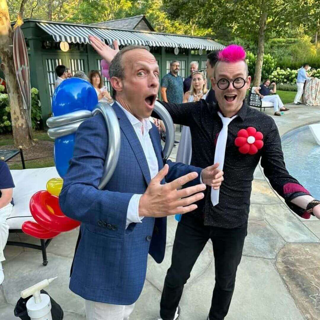 Dave Brenn with another performer ballon artist at lively outdoor party in new york city