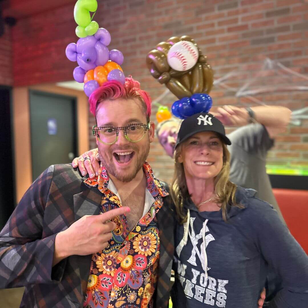 Dave Brenn with guest seated on ornate balloon throne backdrop